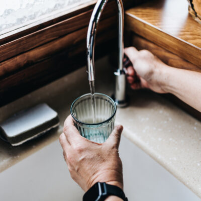 someone using a reverse osmosis water system