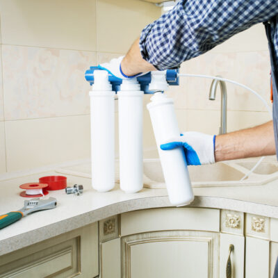 water purification system being installed by a Culligan worker