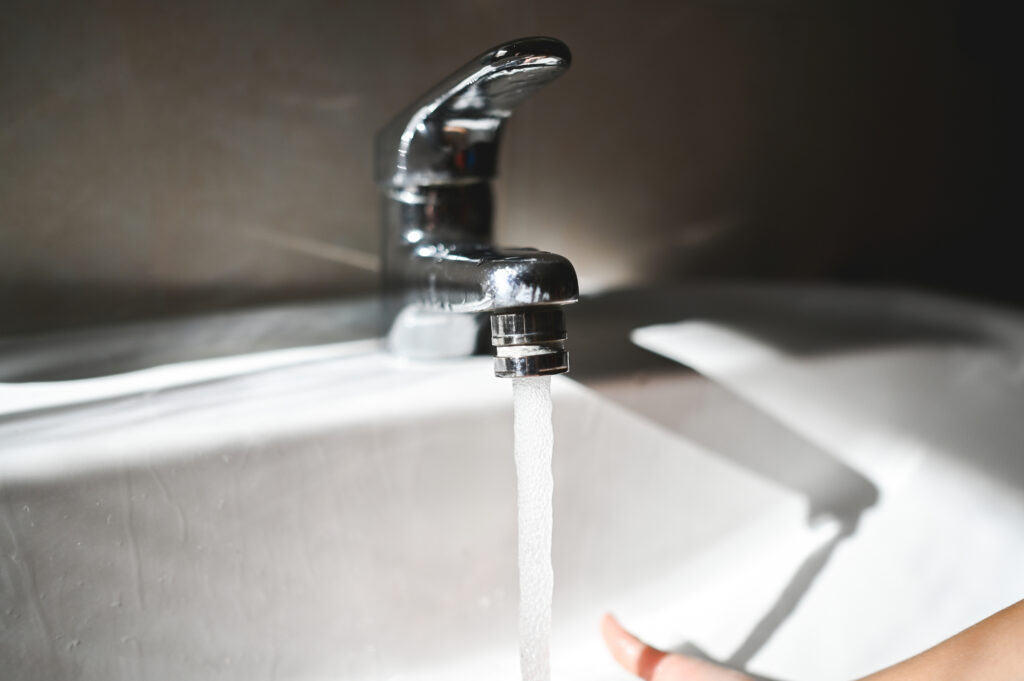 close up shot of water coming out of a faucet