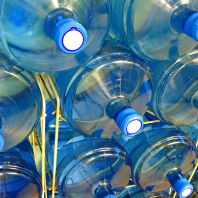 Stack of huge water bottles for office water coolers.