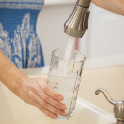 woman filling up water glass